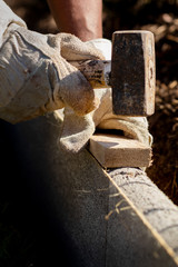 Worker hammers to place a curb