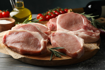 Composition with raw meat for steak and ingredients on wooden background