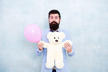 Man wear tuxedo bow tie. Womens day. Stereotype of romantic holidays. Valentines day. Romantic man with teddy bear and air balloon waiting girlfriend. Romantic gift. Macho ready romantic date