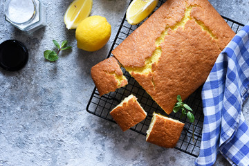 Lemon cake with zest on a concrete background. View from above.