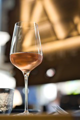 Glass with cold rose wine on a served table
