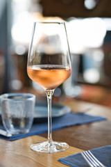 Glass with cold rose wine on a served table
