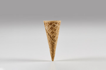 Empty small wafer cone for ice cream isolated on white. Concept of food, treats. Mockup, template for your advertising and design. Close up