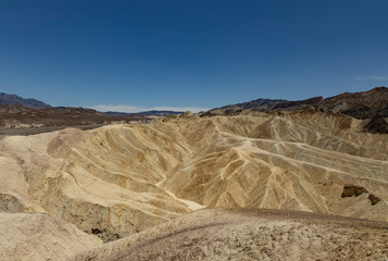 yellow rock waves in death valley