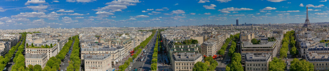 Fototapeta premium PARIS, FRANCE, EUROPE -Panoramic Aerial view of Paris, France as seen from the Arch of Triumph on a sunny day with white puffy clouds, shot August 4, 2015