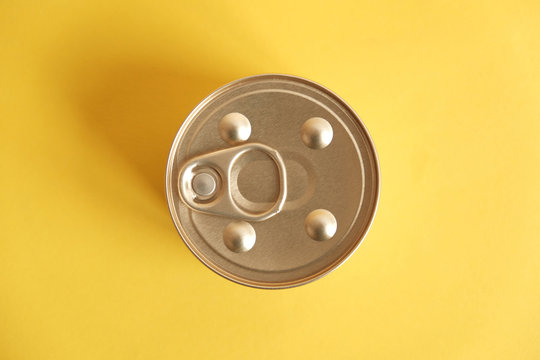 Canned food closed on yellow background. Top view. Copy, empty space for text