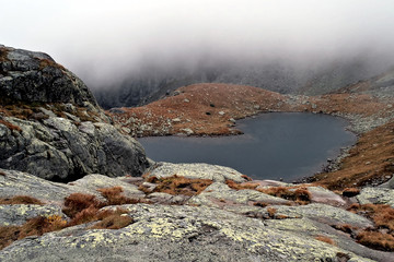 lake in the Tatra mountains surrounded by clouds, in autumn