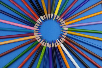 multicolored pencils on a colored background