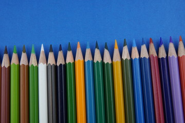 multicolored pencils on a colored background
