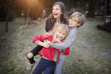 group of young friends are fooling around outside on a sunny day