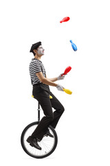 Pantomime guy riding a mono-cycle and juggling © Ljupco Smokovski