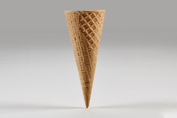 Empty, big wafer cone for ice cream isolated on white. Concept of food, treats. Mockup, template for your advertising and design. Close up