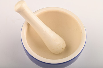 Blue ceramic spice mortar with pestle on white background. Close up.