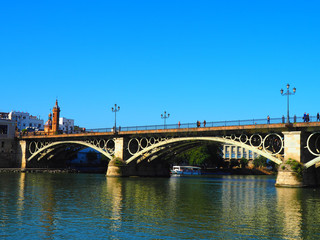 Naklejka na ściany i meble View of the Isabel II Bridge (popularly called Puente de Triana) in Seville, Spain.