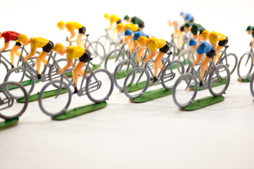 Plastic cyclists in a group running a competition.