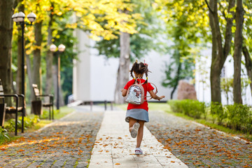 schoolgirl going to school alone