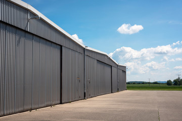 Fototapeta na wymiar Hangar exterior at a small airport. Private aviation