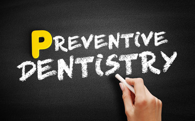 Preventive dentistry text on blackboard, medical concept background