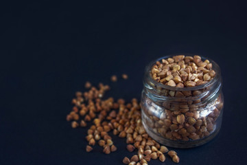 groats, buckwheat on a dark background