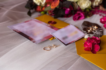 wedding accessories: a bride’s bouquet of roses, peonies and hydrangeas, wedding rings on a...