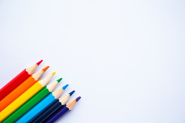 set of colored pencils on a white background with space for text