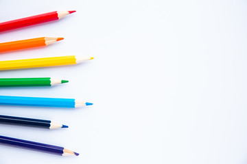set of colored pencils on a white background with space for text