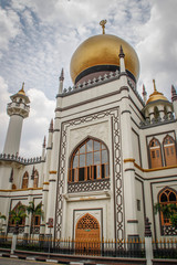 Beautiful Sultan Mosque or Masjid Sultan Mosque in Singapore in the Arab quarter with a golden dome and beautifully decorated white walls.