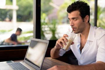 Portrait of handsome Turkish man relaxing at the coffee shop