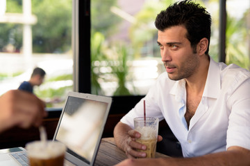 Portrait of handsome Turkish man relaxing at the coffee shop