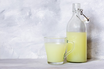 Milk serum. Whey from homemade cottage cheese in a glass mug.