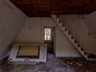 A narrow staircase leading up in an abandoned holiday house