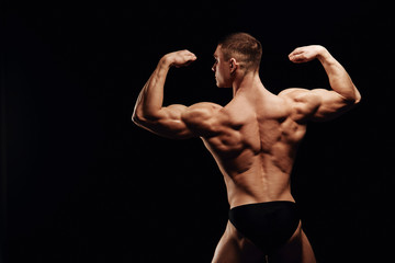 Strong men posing and showing muscles. Great shape before championship. Perfect for sport nutrition promo. Athlete and bodybuilder. Close-ups. Black background.