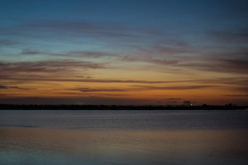 Naklejka na ściany i meble sunrise over lake, launch pad in background, cape canaveral