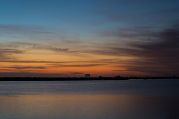Fototapeta na wymiar sunrise over lake, launch pad in background, cape canaveral