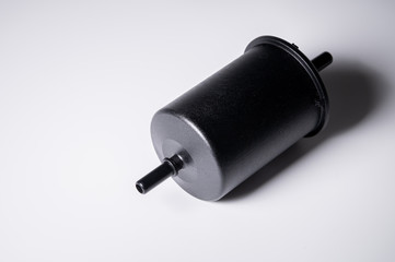 New fuel filter in a black plastic housing for diesel and gasoline engines on a gray background