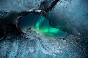 Northern lights aurora borealis over glacier ice caves in Iceland