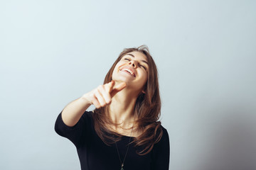 funny cute brunette girl points finger and taunts