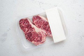 Raw beef Striploin steak in vacuum packaging, layout for the logo design idea