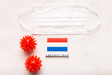Coronavirus 2019-nCoV concept. Top view protective breathing mask and on flag of Netherlands. Novel Chinese Coronavirus outbreak.