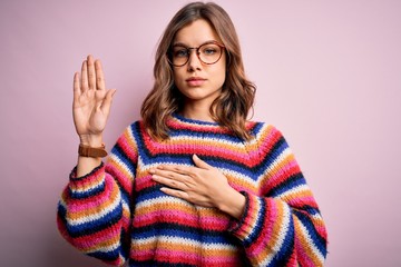 Young beautiful blonde girl wearing glasses and casual sweater over pink isolated background...