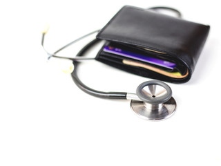 Close up of stethoscope  with money wallet  on top white background with copy space,  healing...