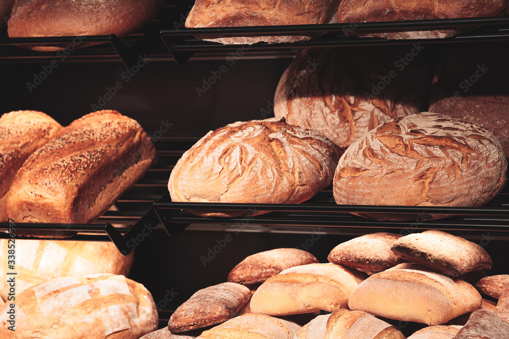 Poster fresh breads on the shelf in the bakery