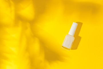 Fingernail polish on yellow background isolation