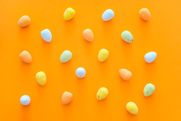Easter eggs on the orange background closeup copy spase