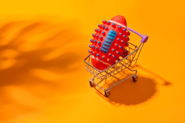 American football ball inside shopping cart. Ball like virus