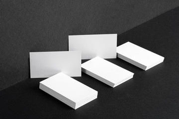 Stacked white businesscards for branding identity on black background, copy space