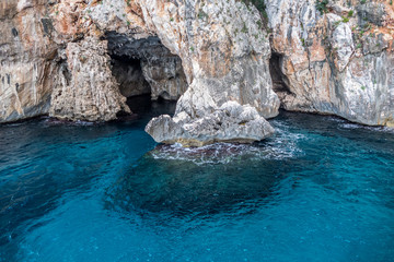 Natural caves in gulf of Orosei with turquoise water