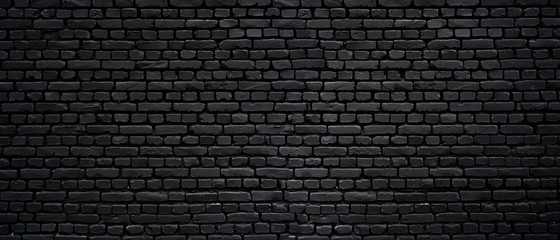 Fototapeta na wymiar Texture of a black painted brick wall as a background or wallpaper