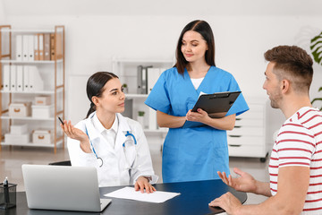 Male patient visiting doctor in clinic