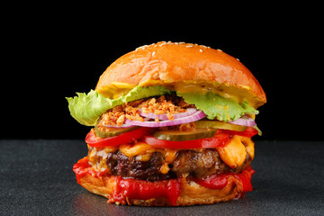 tasty burger with beef on dark isolated background. Homemade hamburger or burger with fresh vegetables and cheese